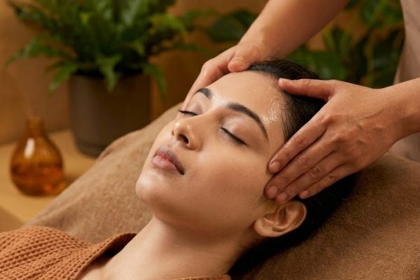 Woman relaxing during an Ayurvedic head massage