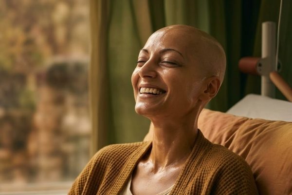 Smiling woman resting comfortably in a chair by a window