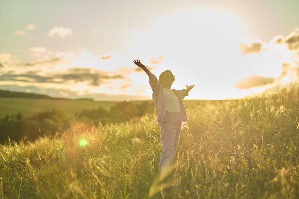 Image of a happy senior woman enjoying a day in nature, reflecting the high quality of life in